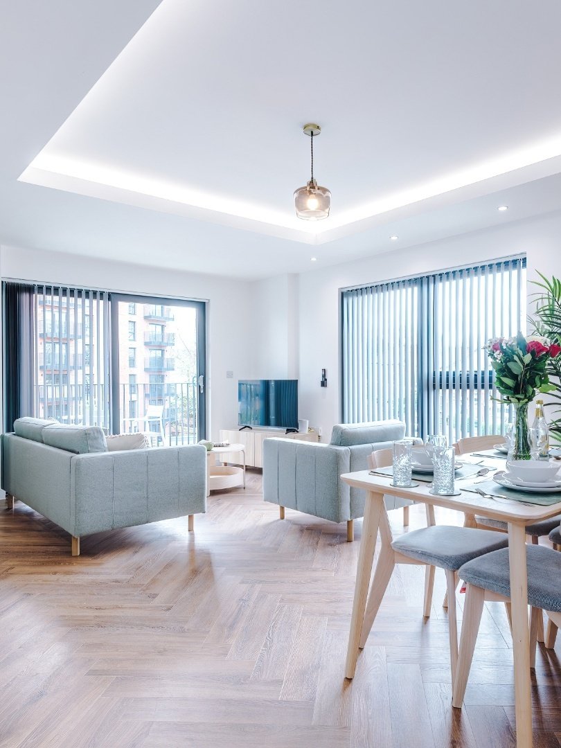 Bright open-plan living and dining area in one of our serviced apartments